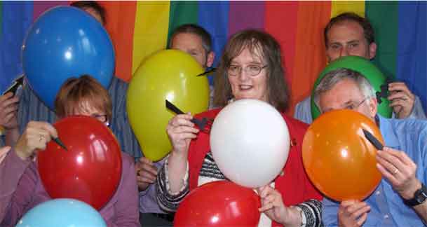 IDAHO members bursting balloons