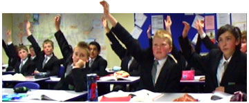 A class of boys with their hands up